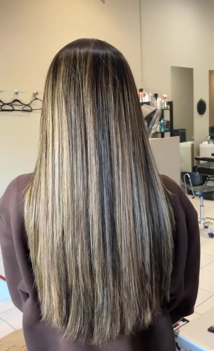 After Nanoplasty: long, sleek, smooth hair with soft blonde pieces, seen from behind